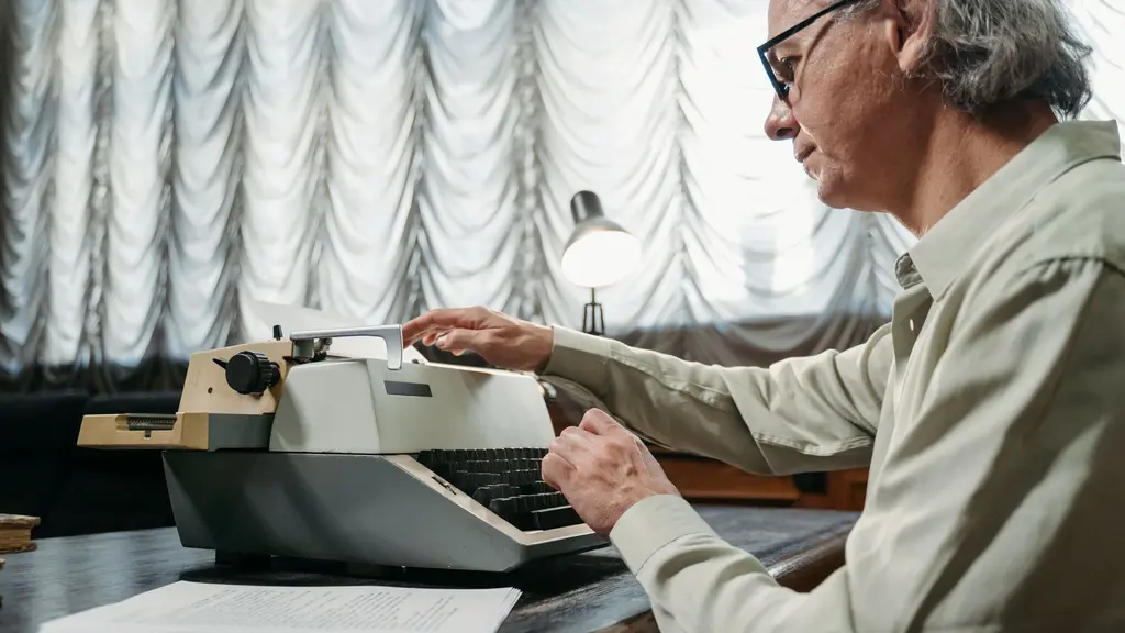a vintage typewriter on a writer's desk under a lamp