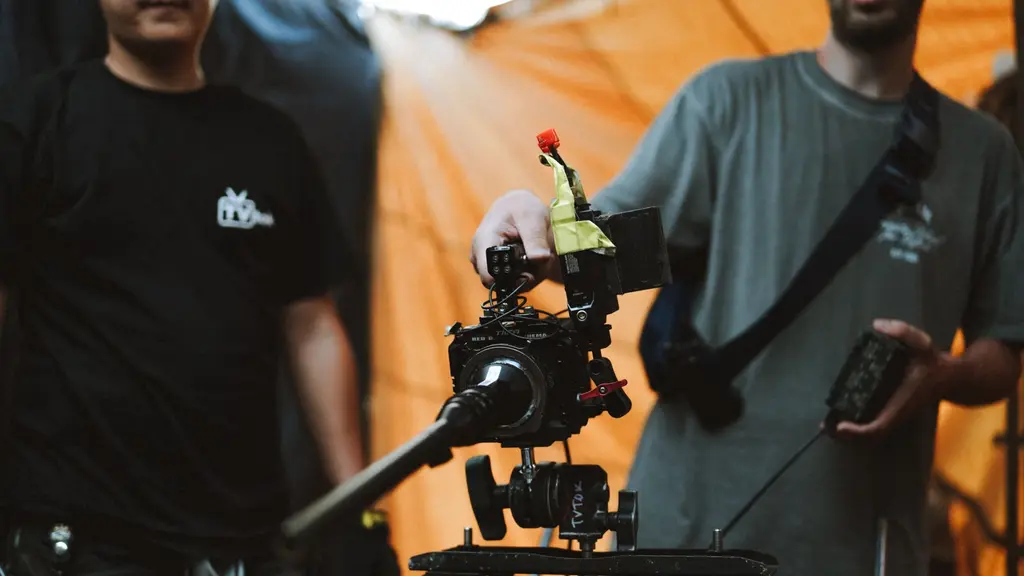 a camera operator on a rooftop at dusk
