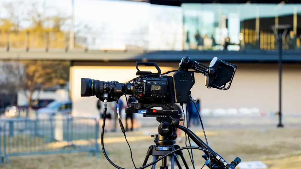 a cinema camera on a tripod in a doorway