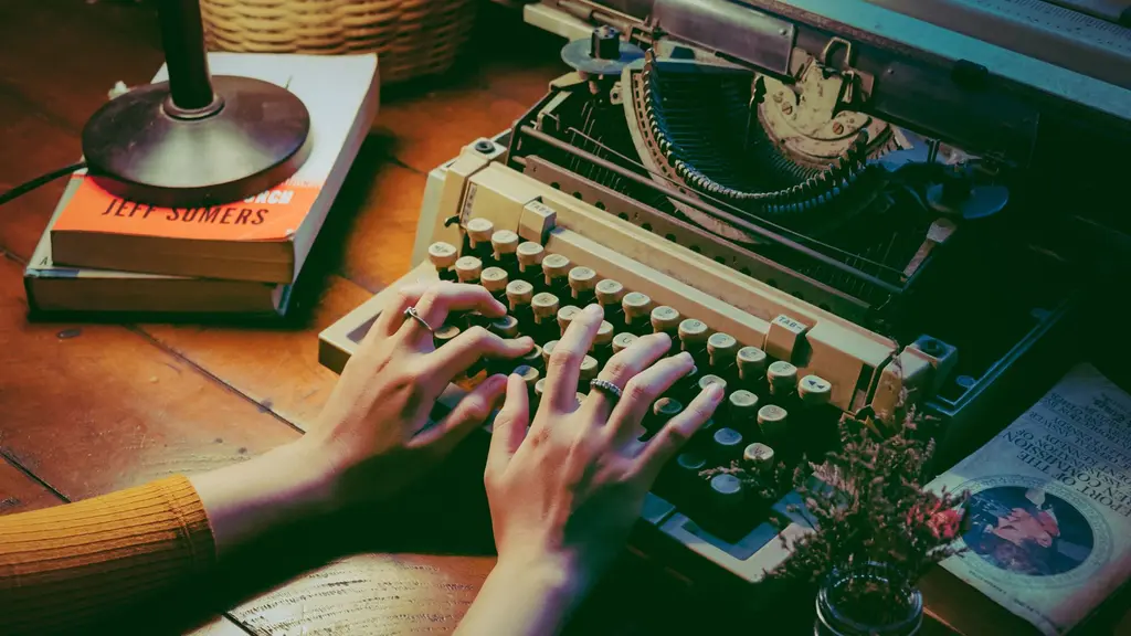 a vintage typewriter on a writer's desk under a lamp