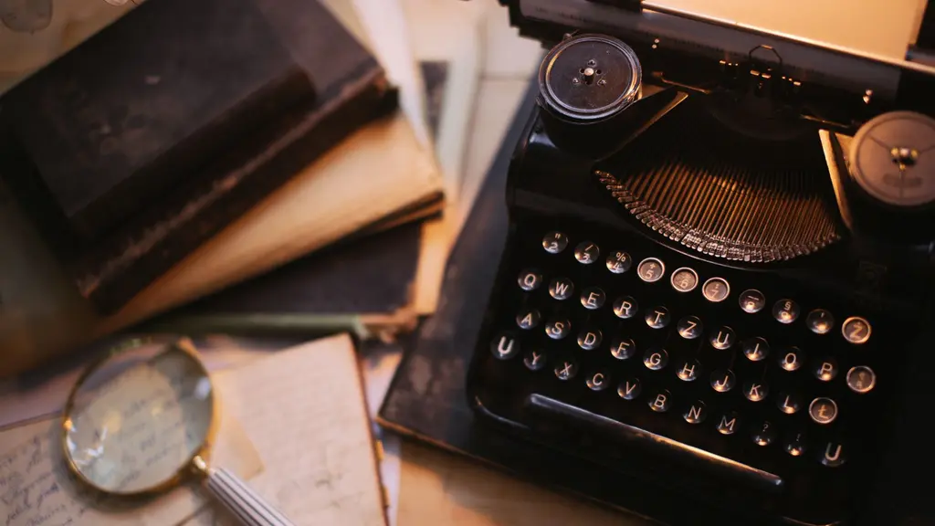 a vintage typewriter on a writer's desk under a lamp