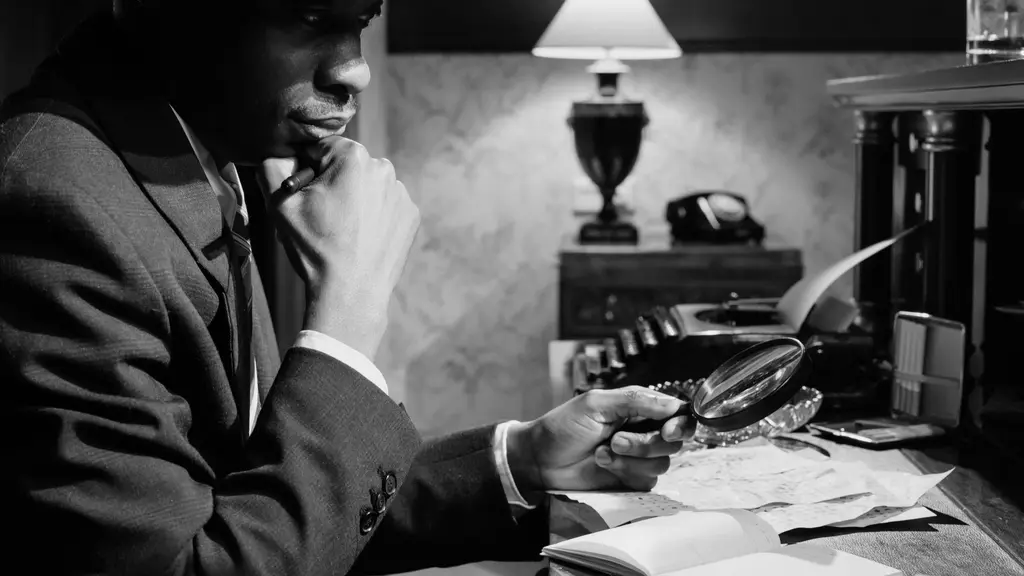 a producer at a desk under a single lamp