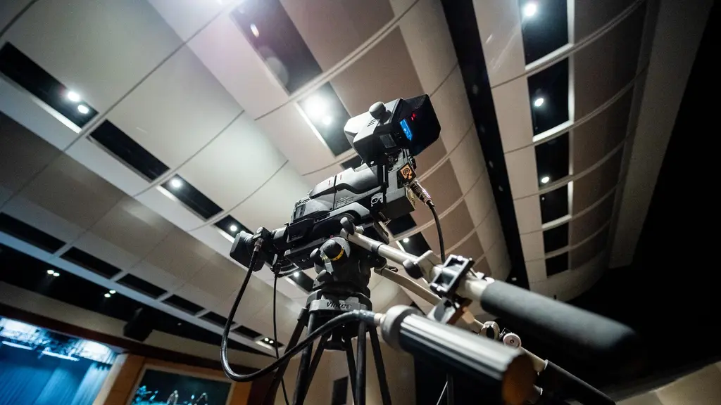 a cinema camera on a tripod in a doorway