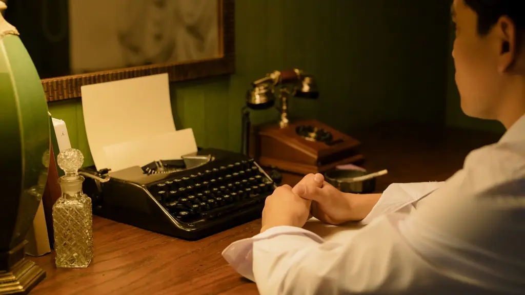 a vintage typewriter on a writer's desk under a lamp