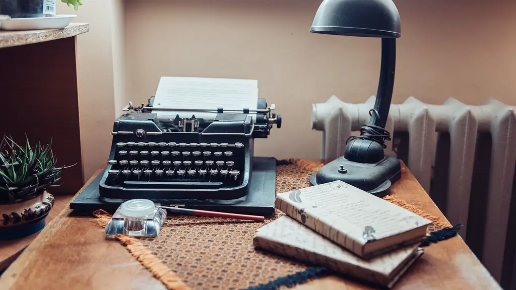 a pen resting on an open notebook beside a window at first light